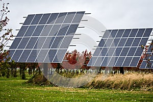 Large Solar panels with autumn trees in the background. Renewable resources