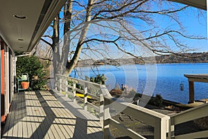 Large spacious deck of grey waterfront home