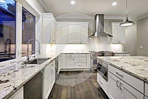 Large, spacious kitchen design with white kitchen cabinets photo