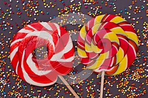 Large spiral lollipops on black background.