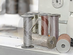 Large spools of thread on a sewing machine