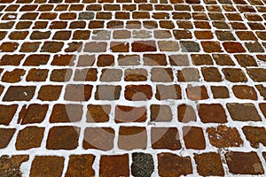 Large square paving stones made of natural stone in winter  under the snow