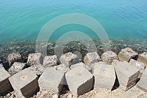 Large square stones breakwaters on seashore of Red Sea