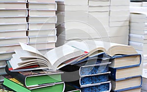 stack of books, close up. Open book on the table in library. Back to school concept.
