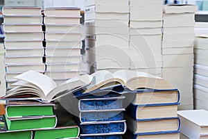stack of books, close up. Open book on the table in library. Back to school concept.