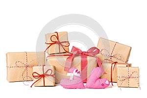 Large Stack of Gift box wrapped in recycled paper with ribbon bow, hearts and christmas ornament