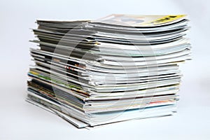 A large stack of printing magazines on a white background. Lots of different publications.