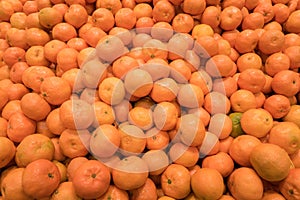 Large stack of vibrant orange clementines