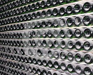 Large stack of wine bottles in winery