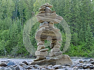 Large stacked stones Inuksuk cairn trail marker