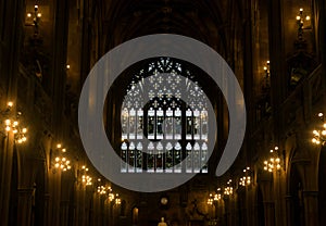 A large stain glassed arched window in a cathedral