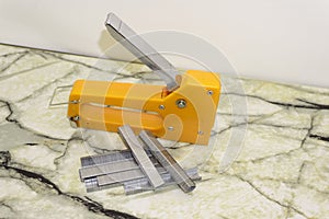 Large stapler and staples for construction work on white