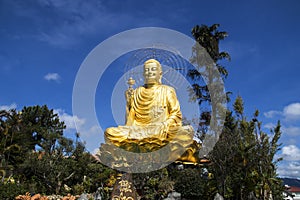 A large statue of golden Buddha. Dalat Vietnam