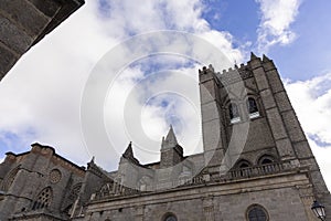 A large stone building with a clock tower and a steeple