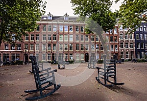 Large stone chairs on the square in Amsterdam.