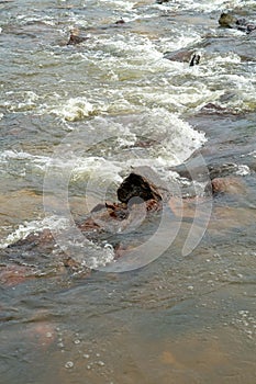 Large stone on the flowing river stream in Malaysia