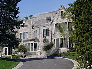 Large stone house with circular driveway