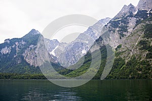 Large stone mountains in the Alps on Konigssee Lake