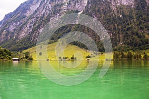 Large stone mountains in the Alps on Konigssee Lake