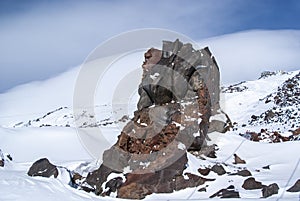 A large stone among the snow-covered hills