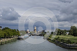 Large stone windmill on a canal in Schiedam, Holland