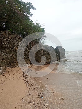 Large stones on the beach make the beach scene more beautiful