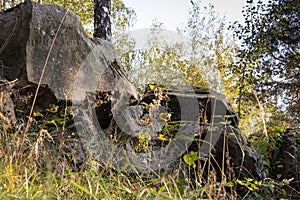 Large stones in the forest against the background of autumn trees.