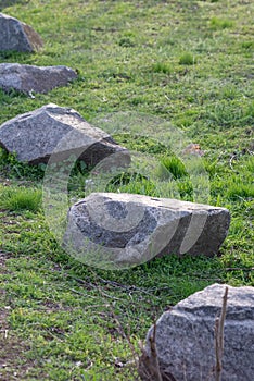 Large stones on green grass. Background, copy space spring