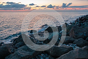 Large stones on the seashore during sunset