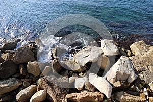 Large stones and shells on the Mediterranean coast