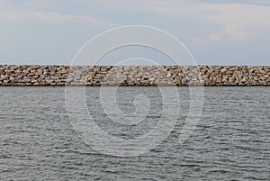 Large stones Was prepared in place of the sandy beach for the wave walls