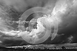 Large storm clouds darken the blue sky