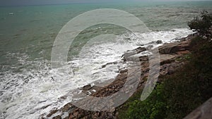 Large storm waves crashing on rocks in slow motion