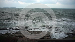 Large storm waves crashing on rocks in slow motion