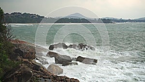 Large storm waves crashing on rocks in slow motion