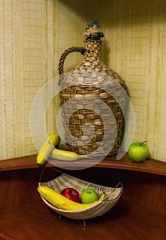 Large straw bottle and fruits