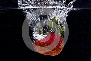 Large strawberry dropped in water