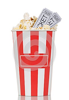 Large striped popcorn box and gray movie ticket isolated on white