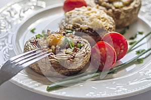 Large stuffed mushrooms beautifully preserved on a white plate