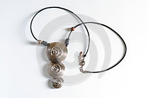 A large and stylish necklace around the neck of their metal circles