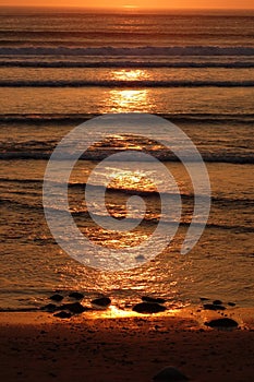 Large sunlight street on the ocean water . Beautiful sunset in an orange colored sky . sligo strandhill ocean links connacht .