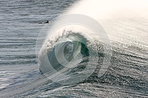 Large surf wave breaking with barrel view.