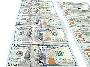 Large surface covered with US cash notes.High angle view of US hundred cash notes carefully spread out on the desk