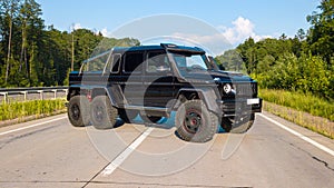 Large SUV 6x6 stands on the road