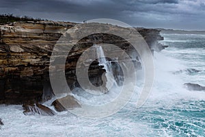 Large swells batter the cliffs of Sydney