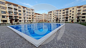 Large swimming pool with at a luxury tropical apartment resort complex.