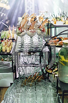 Large table with snacks of different types at a party with creative disco lighting.