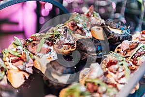 Large table with snacks of different types at a party with creative disco lighting.