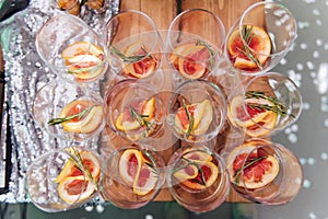 Large table with snacks of different types at a party with creative disco lighting.