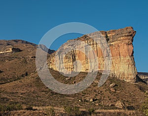 large tall cliff with sunlight on it Brandwag Buttress sandstone cliff Golden Gate Highlands National Park South Africa